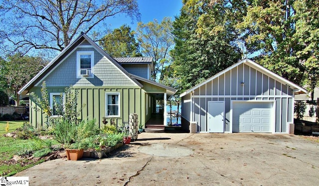 view of front of house featuring a garage, an outdoor structure, and cooling unit