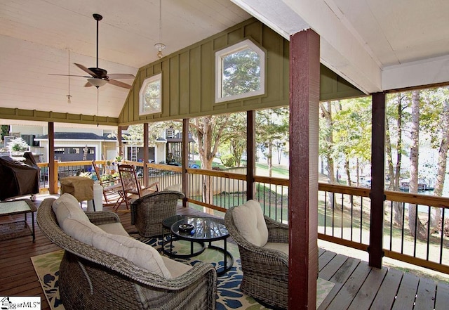 sunroom / solarium with ceiling fan, a healthy amount of sunlight, and vaulted ceiling