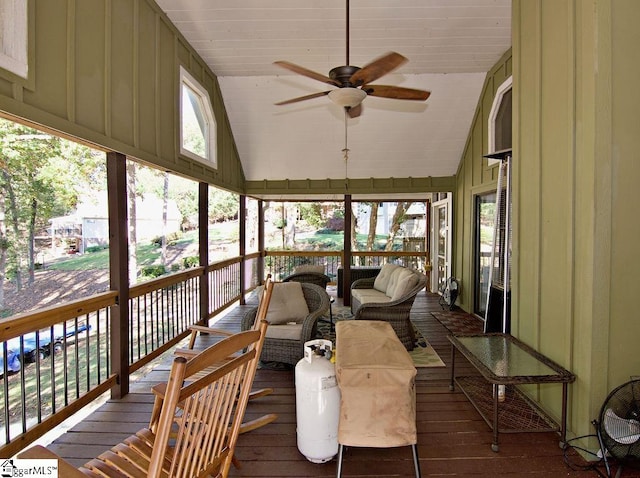 sunroom / solarium with ceiling fan, plenty of natural light, and vaulted ceiling