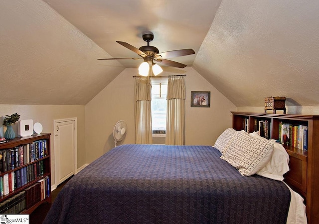 bedroom featuring ceiling fan, a textured ceiling, and vaulted ceiling