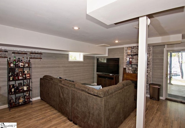 living room featuring wood walls and wood-type flooring