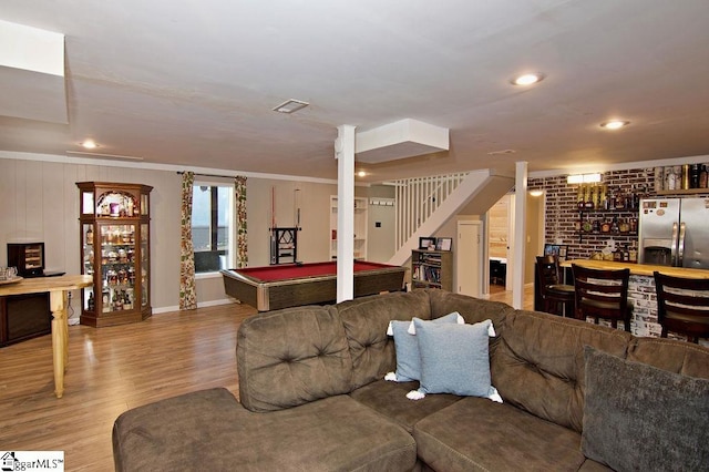 living room with ornamental molding, pool table, and light hardwood / wood-style floors