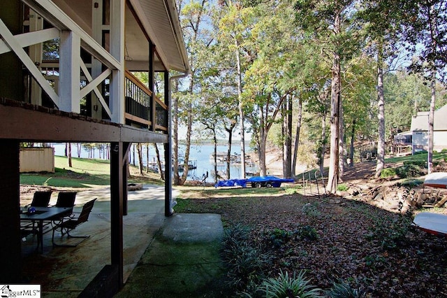 view of yard featuring a water view and a patio area