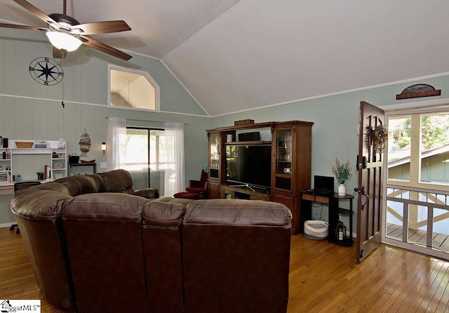 living room with wood-type flooring, ceiling fan, and vaulted ceiling