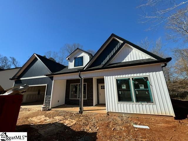 view of front of home featuring a garage and a porch