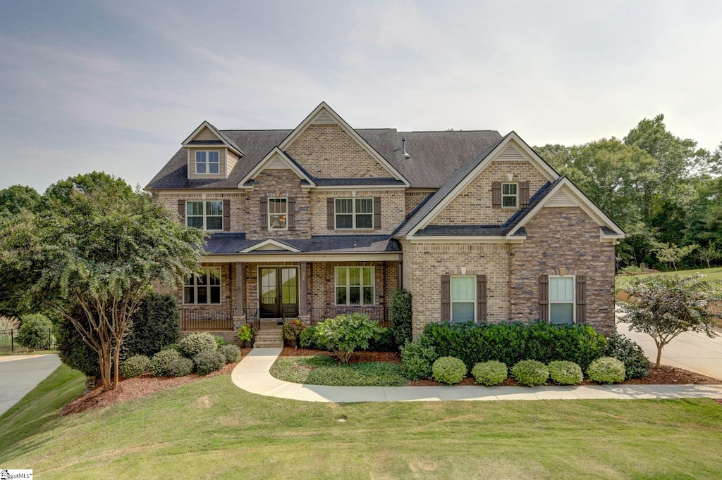 craftsman house featuring a front yard and covered porch