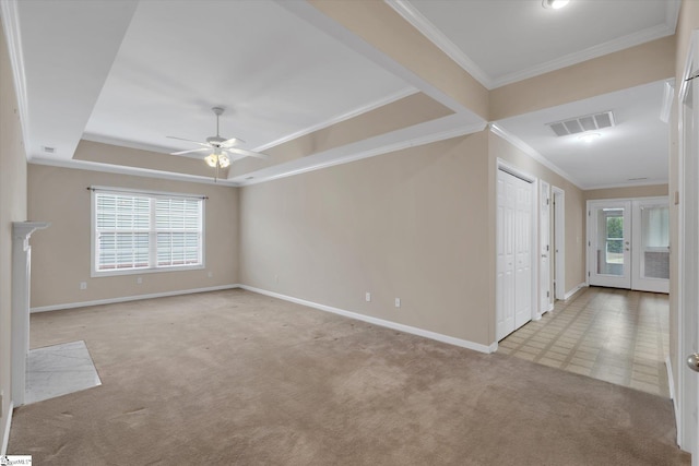 spare room featuring a wealth of natural light, light colored carpet, ceiling fan, and crown molding