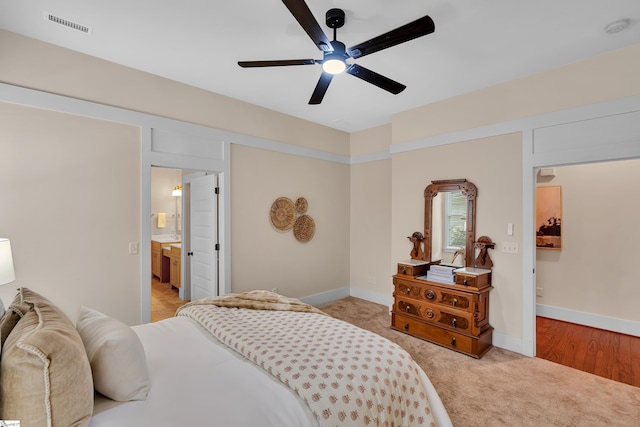 carpeted bedroom featuring ceiling fan and connected bathroom