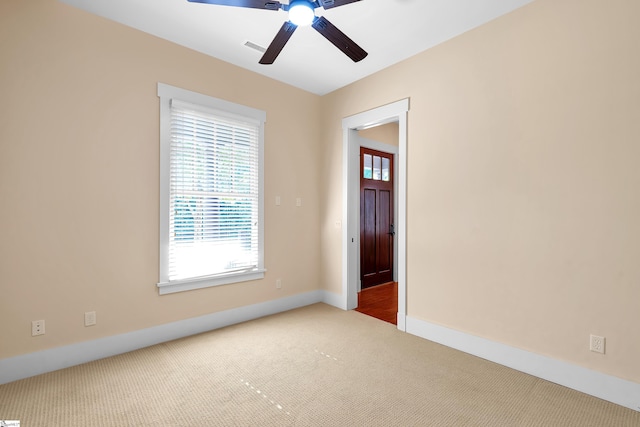 empty room featuring carpet floors and ceiling fan