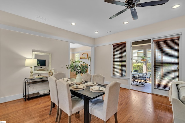 dining room with ceiling fan and light hardwood / wood-style flooring