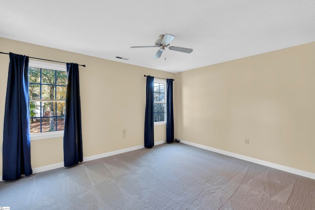 empty room featuring light carpet and ceiling fan