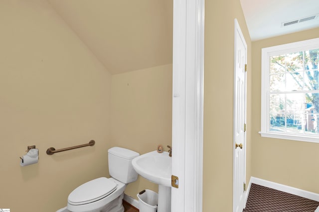 bathroom featuring toilet and vaulted ceiling