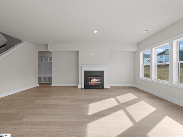 unfurnished living room with light hardwood / wood-style flooring