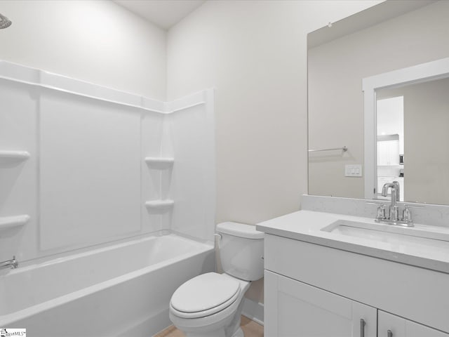 full bathroom featuring washtub / shower combination, vanity, and toilet