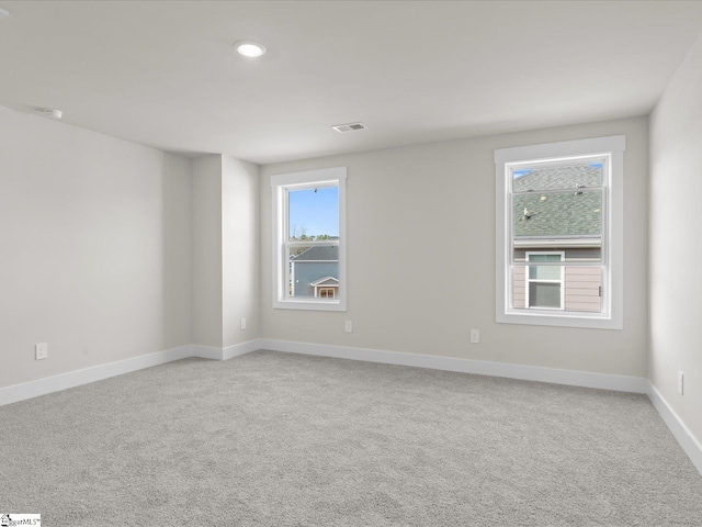 empty room featuring light carpet