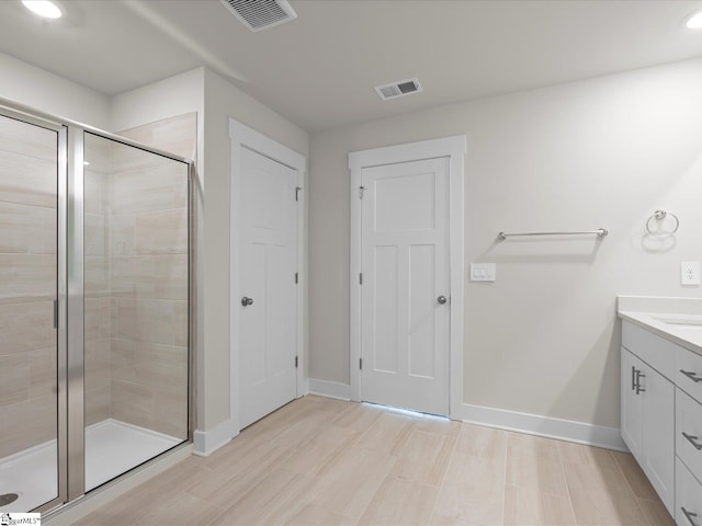 bathroom featuring vanity and a shower with shower door