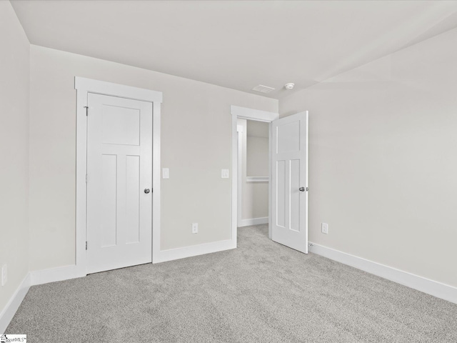 unfurnished bedroom featuring light colored carpet