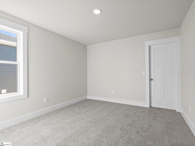 spare room with plenty of natural light and carpet flooring