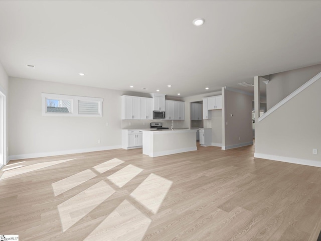 unfurnished living room with light hardwood / wood-style floors