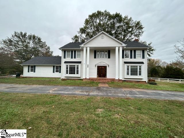 neoclassical / greek revival house with a front lawn