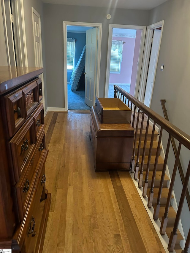 hallway with light hardwood / wood-style flooring