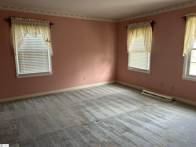 carpeted spare room featuring a wealth of natural light