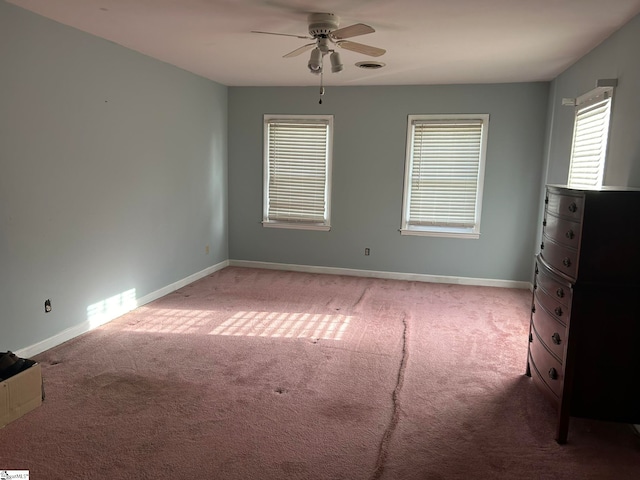 spare room featuring ceiling fan and light carpet