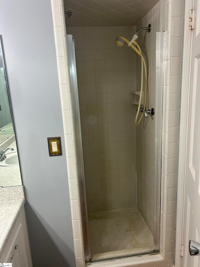 bathroom featuring vanity and a shower with shower door