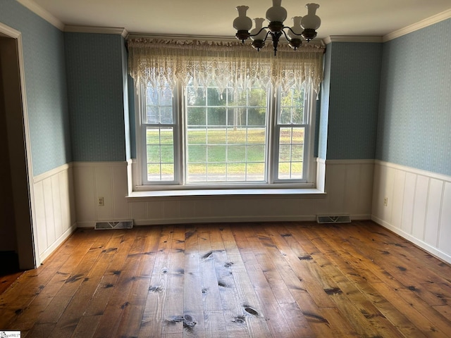 unfurnished dining area with a chandelier, hardwood / wood-style floors, and a wealth of natural light