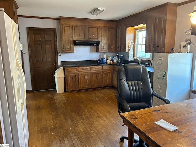 kitchen with sink, dark hardwood / wood-style flooring, white fridge with ice dispenser, and crown molding