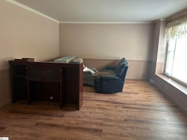 sitting room featuring hardwood / wood-style floors and ornamental molding