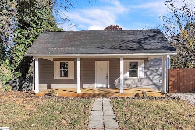 bungalow-style house with covered porch and a front lawn