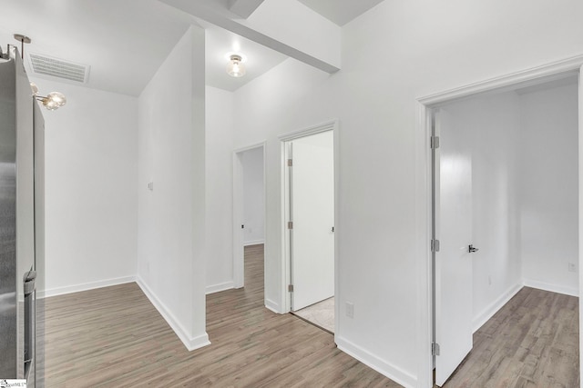 corridor with light hardwood / wood-style flooring