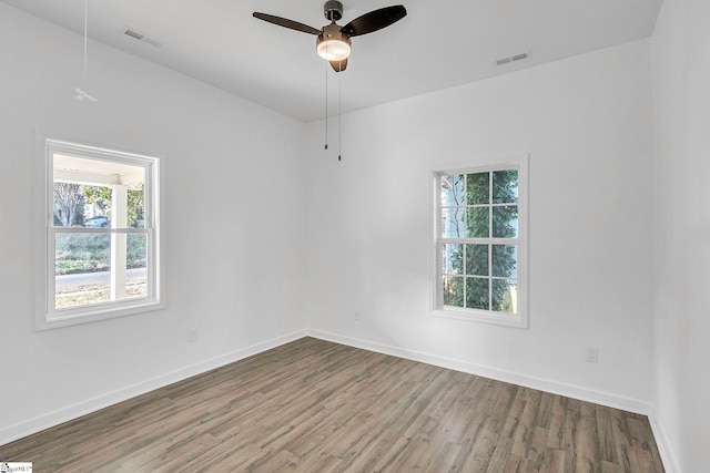 unfurnished room with hardwood / wood-style flooring, plenty of natural light, and ceiling fan