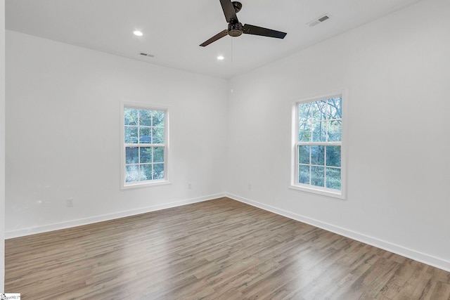 unfurnished room with ceiling fan and wood-type flooring