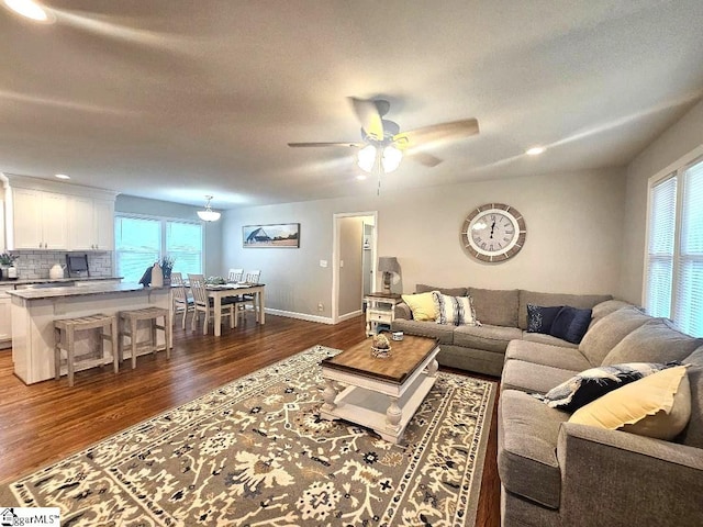 living room with ceiling fan and dark hardwood / wood-style floors