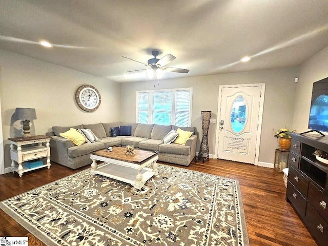 living room with ceiling fan and dark hardwood / wood-style floors