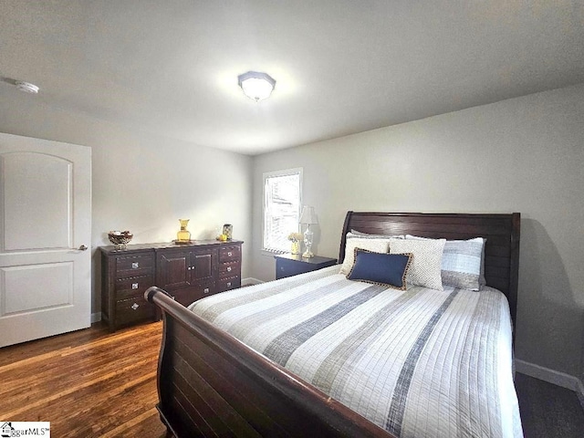 bedroom with dark wood-type flooring