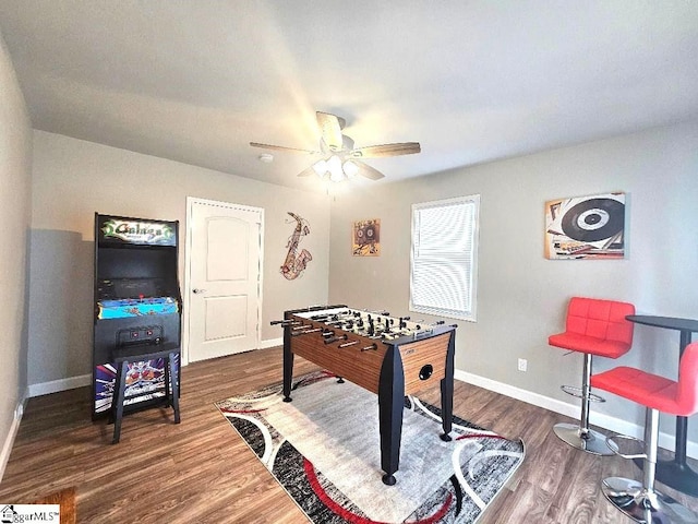 recreation room featuring dark wood-type flooring and ceiling fan