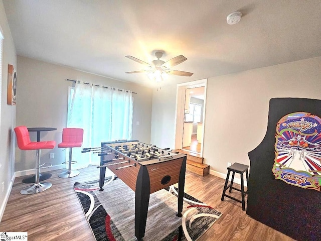 recreation room with hardwood / wood-style flooring and ceiling fan