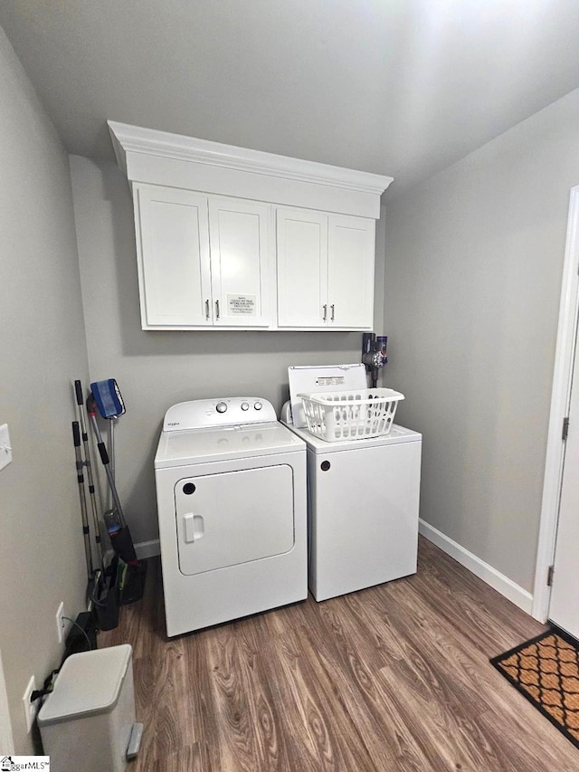 washroom featuring cabinets, dark hardwood / wood-style floors, and independent washer and dryer