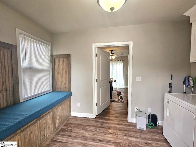 clothes washing area with washer / clothes dryer, dark wood-type flooring, and ceiling fan