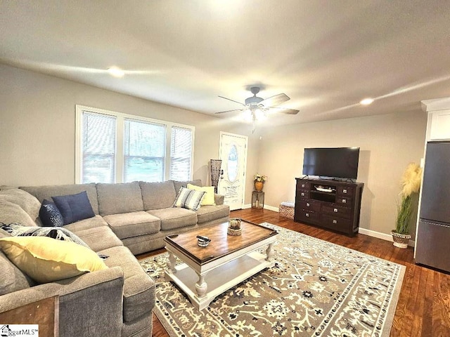 living room with dark wood-type flooring and ceiling fan