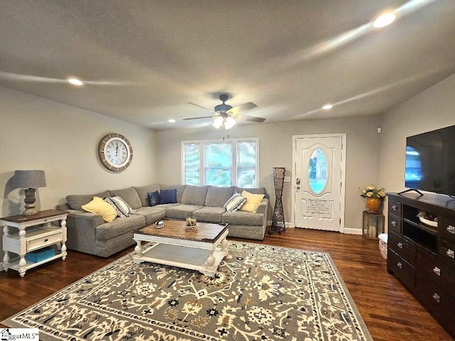 living room featuring ceiling fan, dark hardwood / wood-style floors, and a textured ceiling