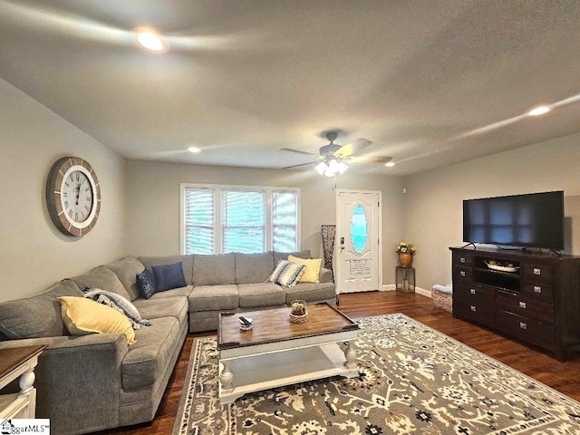 living room with ceiling fan and dark hardwood / wood-style floors