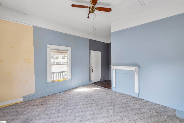 empty room with dark colored carpet and ceiling fan