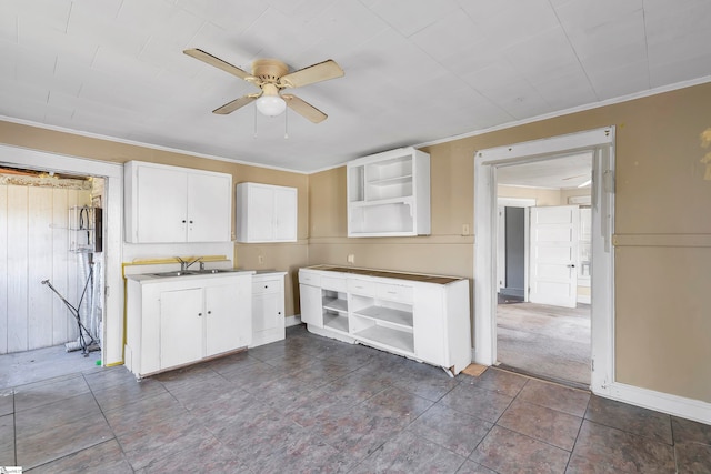 315 Poole St, Woodruff, SC 29388 - kitchen featuring white cabinets, ceiling fan, sink, and crown molding