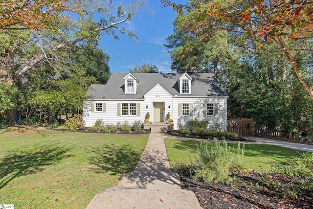 cape cod house with a front yard