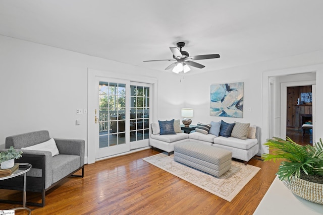 living room with wood-type flooring and ceiling fan