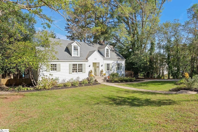 new england style home featuring a front lawn